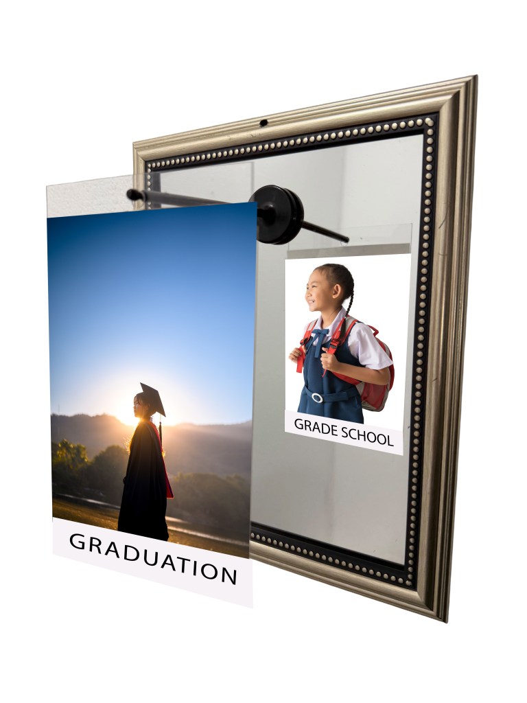 A decorative mirror featuring two photos: one of a graduate in a cap and gown at sunset labeled 'GRADUATION', and another of a young child with a backpack labeled 'GRADE SCHOOL'.